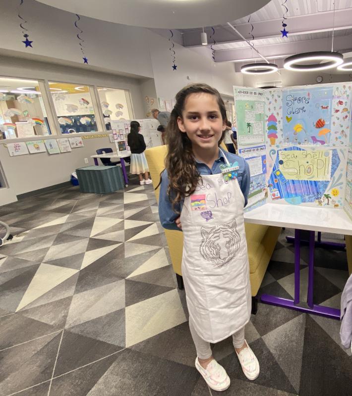 During tours of the building, second-grader Aariona Wolf describes the job of a sea shell shop clerk.